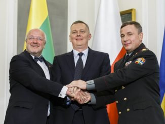 Ukrainian Defense Minister Valeriy Heletey (R), Polish Defense Minister Tomasz Siemoniak (C) and Lithuanian Defense Minister Juozas Olekas shake hands after signing an agreement on the creation of a joint military brigade on Sept. 19 in Warsaw.