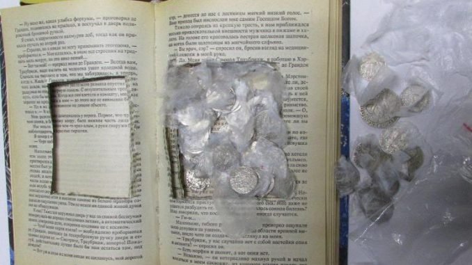 Old coins found inside a book. Photo: Customs Department