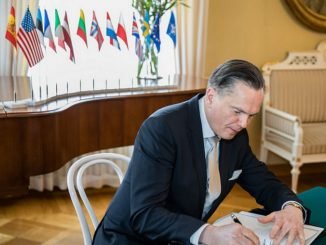 Ambassador at Large, H.E. Eitvidas Bajarūnas signs the document in Helsinki