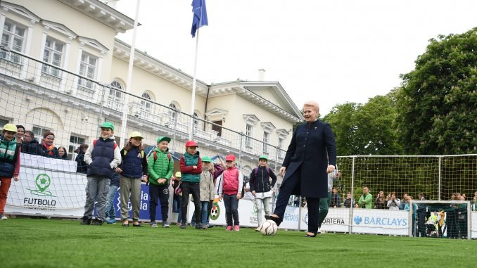 President Grybauskaitė plays football in the front of the Presidential palace in Vilnius.  July 2 2017